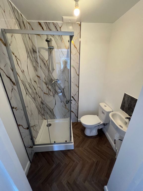 Property photo 2 of 9 A Modern Bathroom Featuring A Stylish Shower Enclo...
