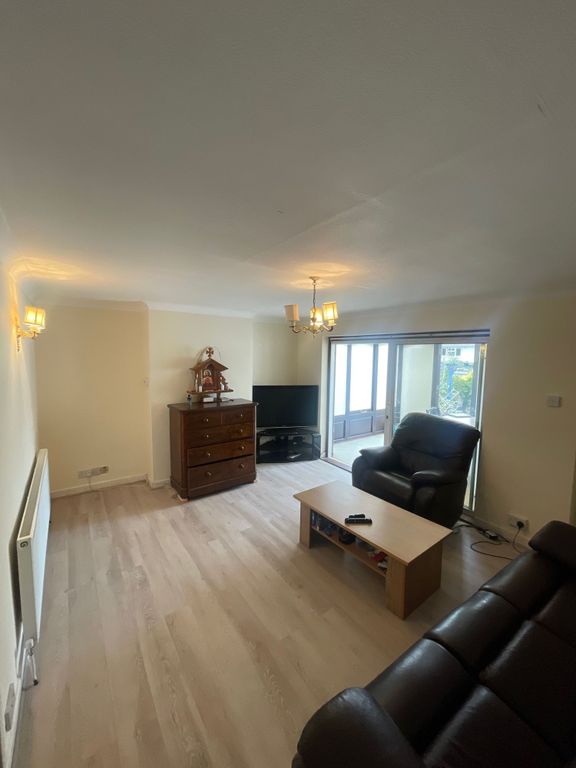 Property photo 2 of 7 A Bright And Welcoming Living Room Featuring Comfo...