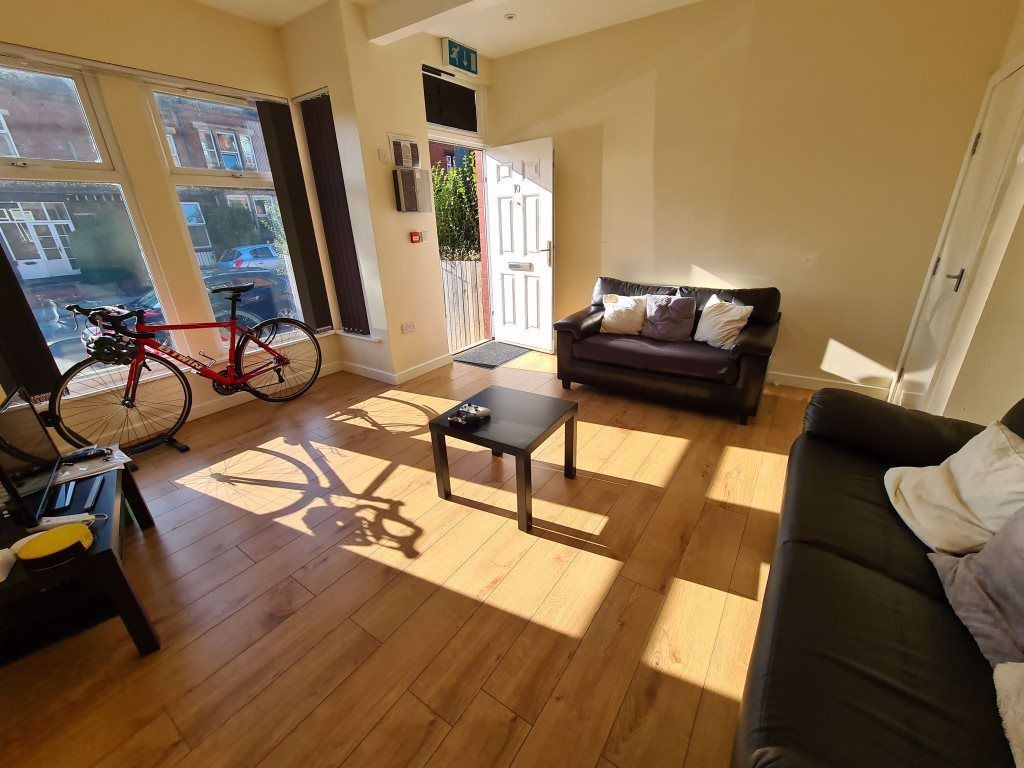 Property photo 2 of 24 Bright And Spacious Living Room Featuring Large Wi...