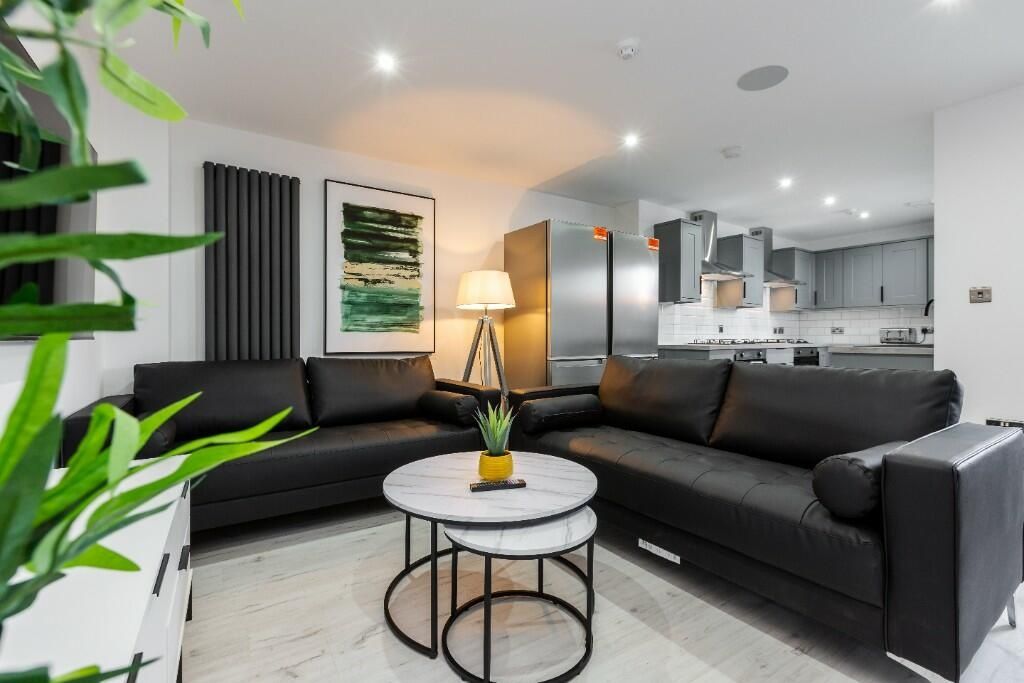 Property photo 1 of 15 A Modern And Spacious Living Room Featuring Comfor...