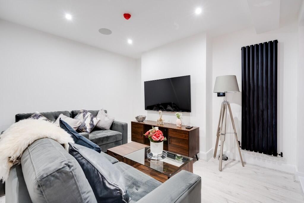 Property photo 2 of 14 A Modern, Spacious Living Room Featuring Comfortab...