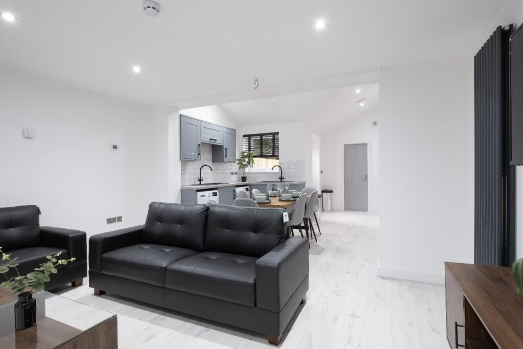 Property photo 1 of 11 A Modern, Bright Living Room With Sleek Black Sofa...