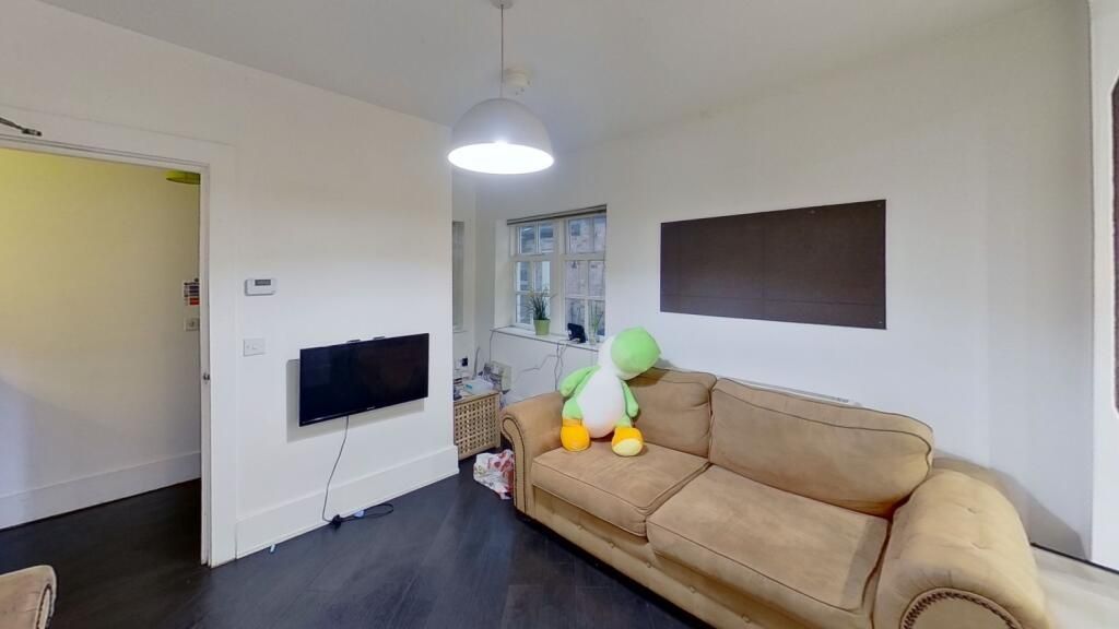 Property photo 3 of 11 A Cozy And Neat Living Room Featuring A Comfortabl...