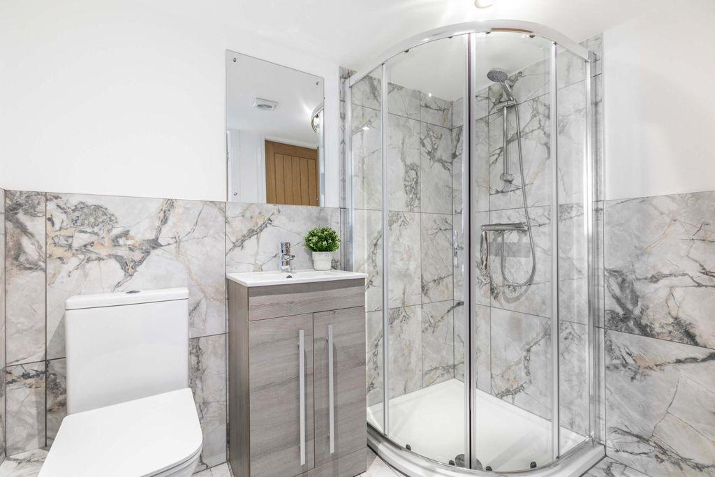 Property photo 3 of 7 Bright, Modern Bathroom Featuring A Corner Glass S...