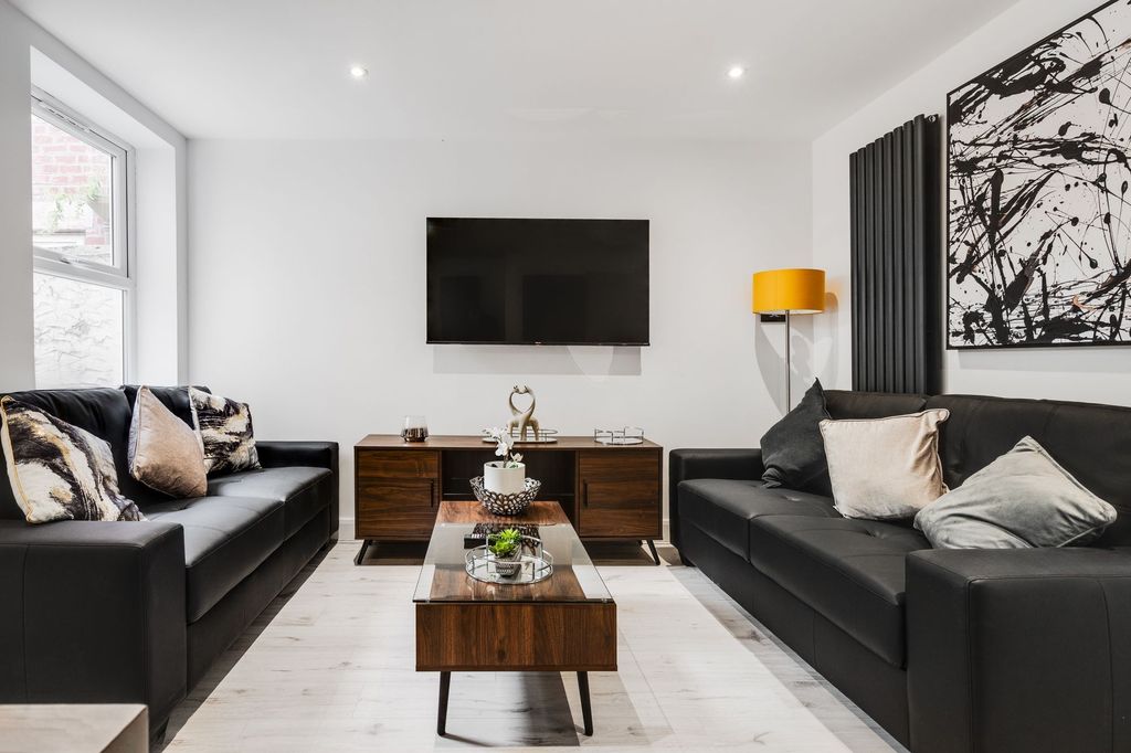 Property photo 1 of 4 Modern And Stylish Living Room Featuring Two Black...