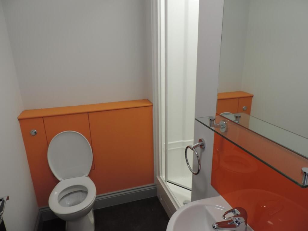 Property photo 2 of 4 Modern Bathroom With Vibrant Orange Accents...