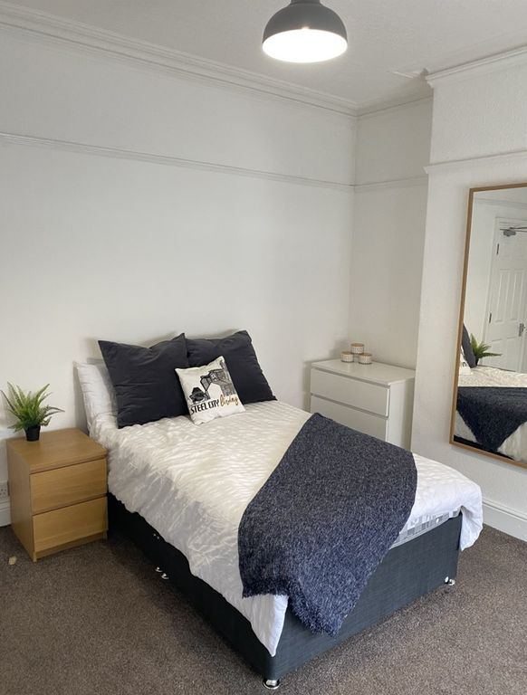 Property photo 3 of 15 This Inviting Double Bedroom Features A Cozy Bed A...