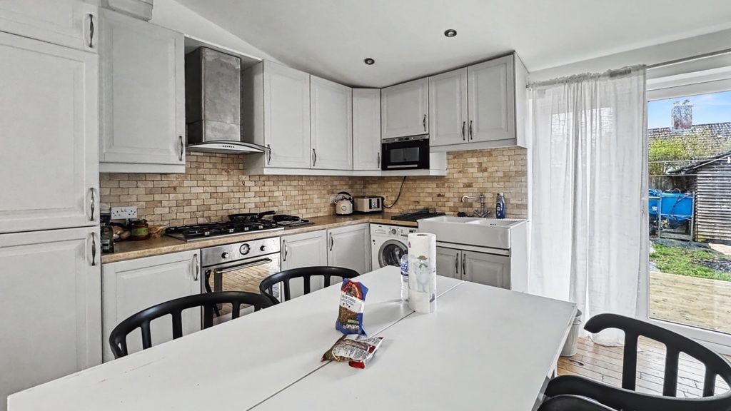 Property photo 3 of 12 Bright Modern Kitchen With White Cabinetry, Integr...