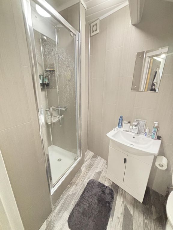 Property photo 3 of 13 A Clean And Modern Bathroom Featuring A Shower Enc...