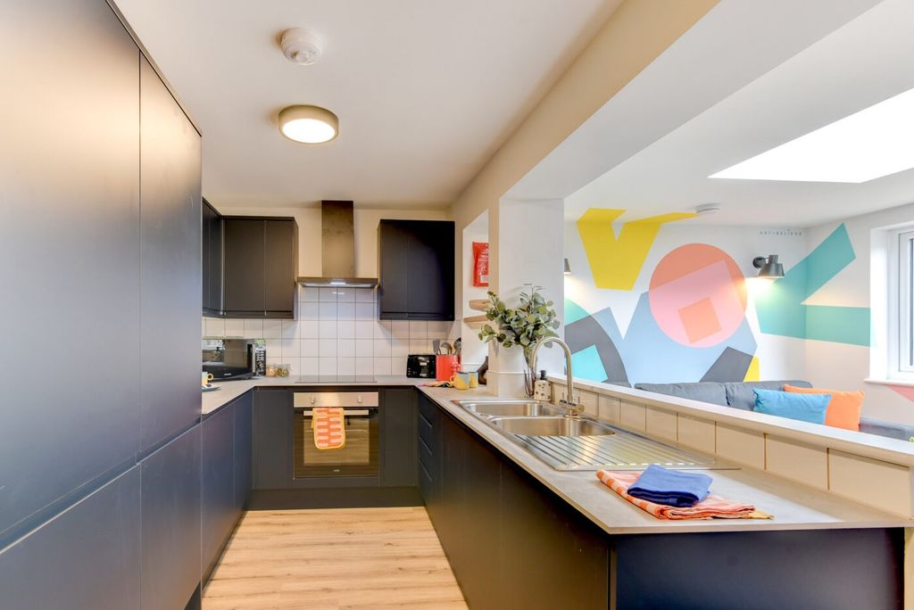 Property photo 2 of 6 Bright Modern Kitchen With Dark Cabinetry, Stainle...