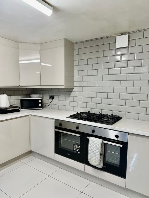 Property photo 2 of 30 A Clean And Modern Kitchen Featuring White Tiled W...