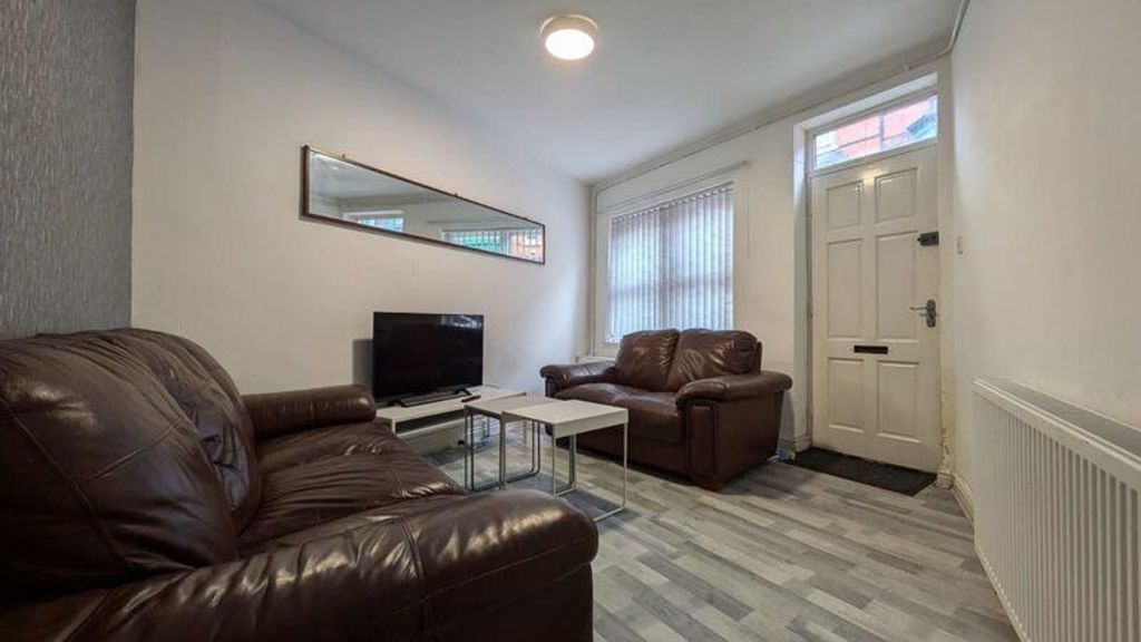 Property photo 3 of 9 A Bright And Inviting Living Room Featuring Comfor...