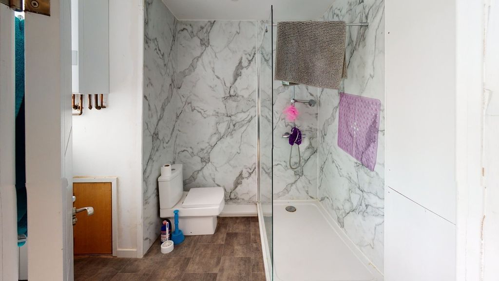 Property photo 1 of 6 A Modern Bathroom Featuring Marble Walls And A Cle...