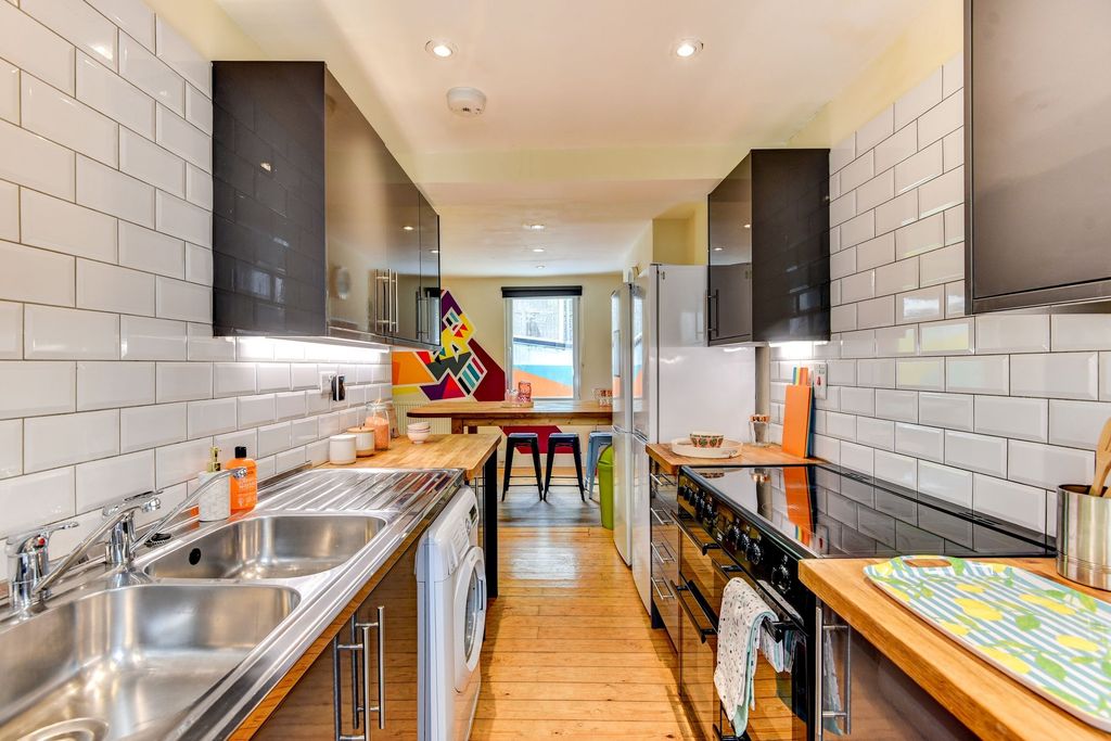 Property photo 2 of 5 Bright And Modern Galley Kitchen With Stylish Blac...