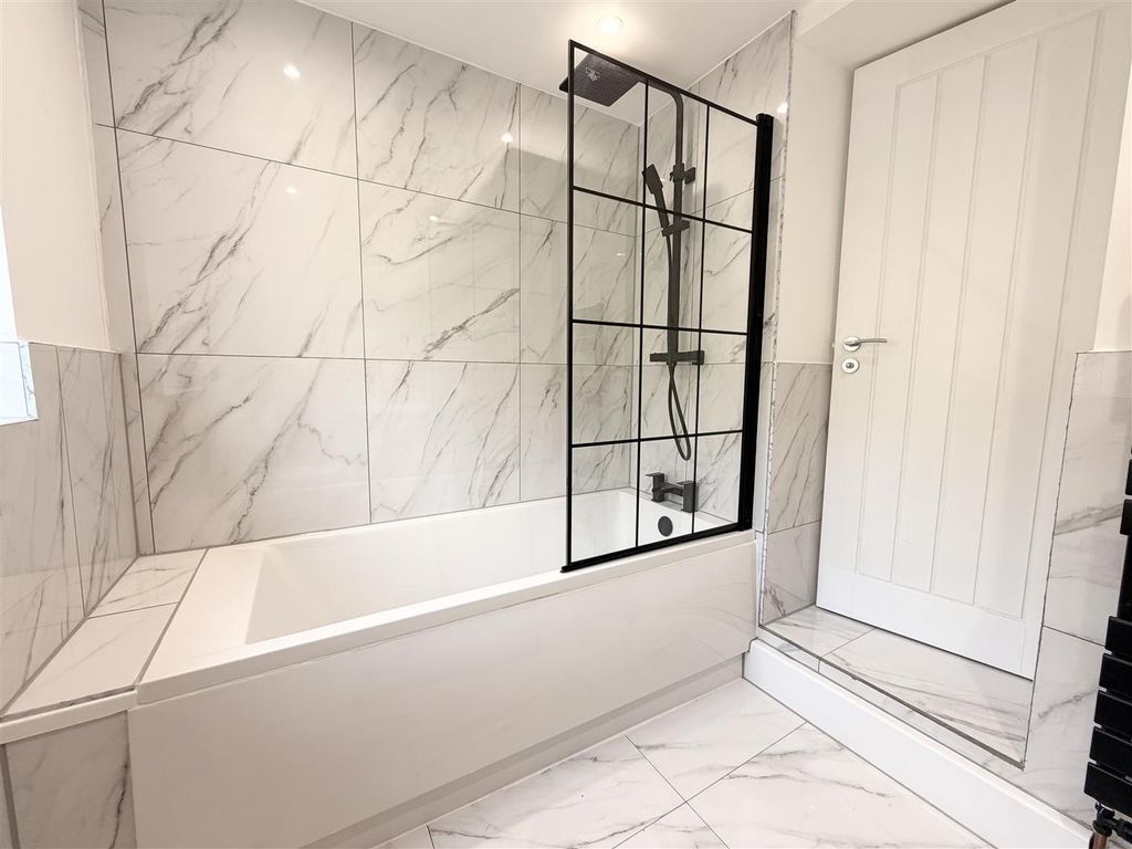 Property photo 2 of 26 Elegant Marble-Tiled Bathroom With Modern Bath And...