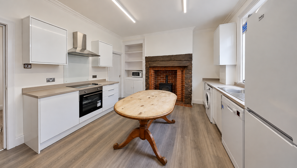 Property photo 3 of 10 Bright Minimalist Kitchen With Oval Wood Table