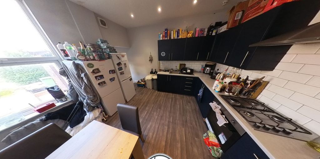 Property photo 3 of 7 A Modern Kitchen Featuring Sleek Black Cabinetry A...