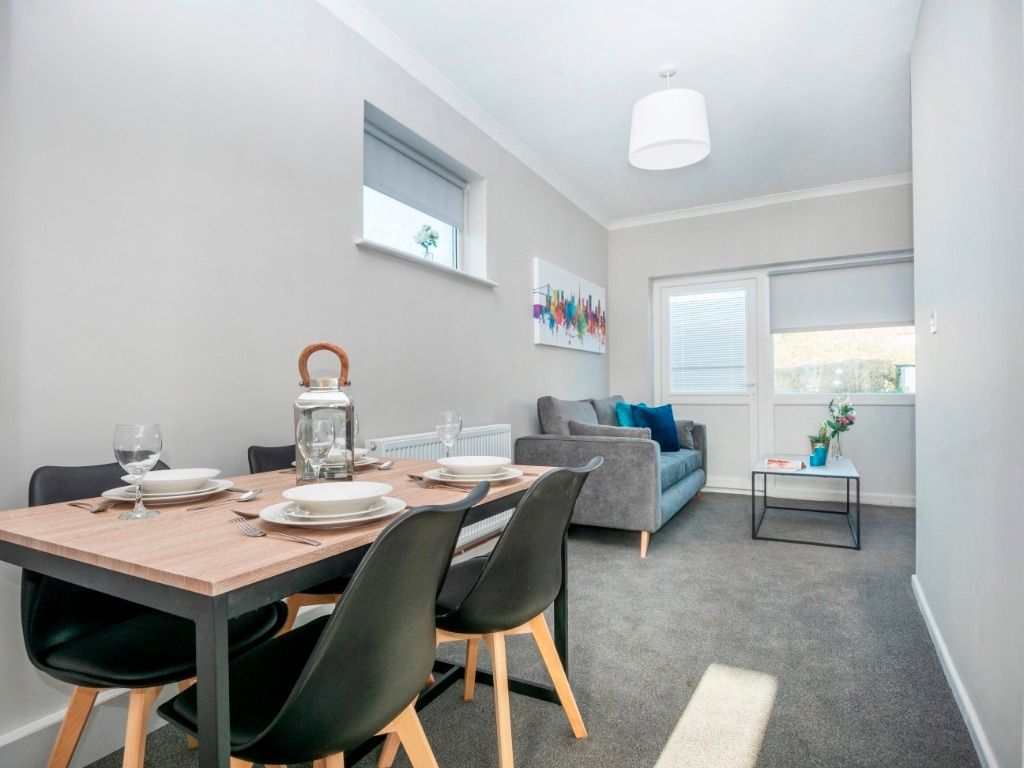 Property photo 1 of 9 A Bright And Inviting Living Room Featuring A Cozy...