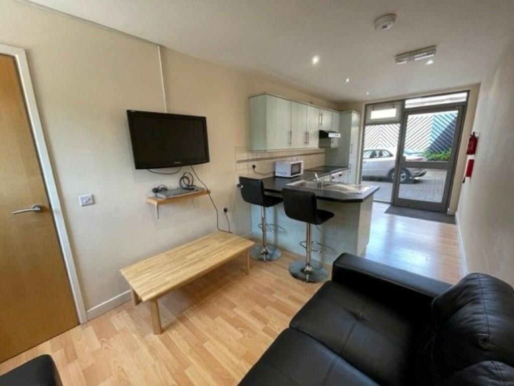 Property photo 1 of 6 Bright And Modern Living Room With A Sleek Black S...
