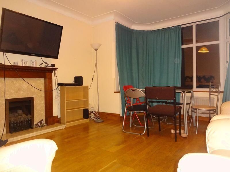 Property photo 1 of 7 A Cozy Living Room Featuring A Fireplace, Large Wi...