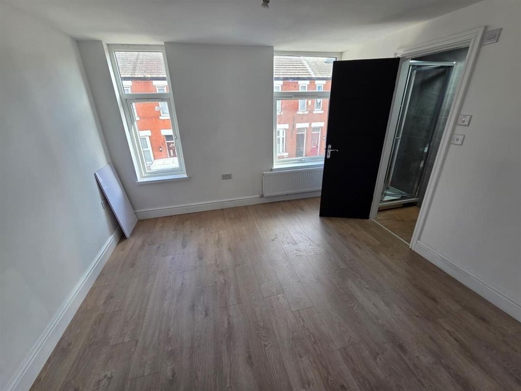 Property photo 2 of 8 Bright Master Bedroom With Sleek Wood Flooring...