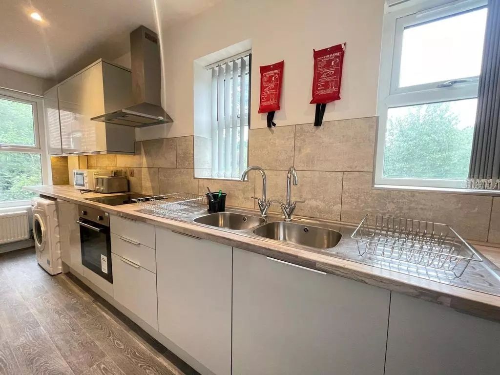 Property photo 2 of 4 Bright And Modern Kitchen Featuring Sleek Cabinetr...