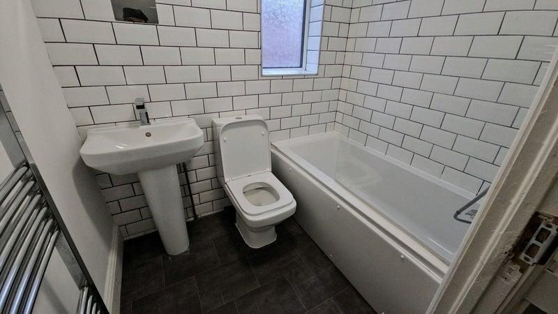 Property photo 2 of 16 Modern Tiled Bathroom With Bath And Towel Rail...