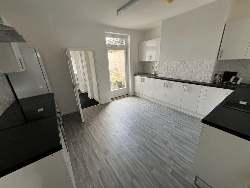 Property photo 3 of 10 A Spacious, Modern Kitchen With Sleek White Cabine...
