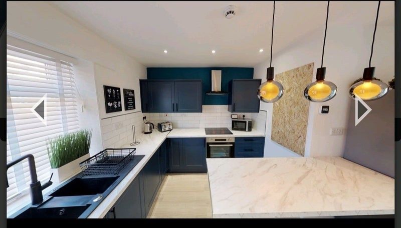 Property photo 3 of 9 A Modern, Stylish Kitchen Featuring Sleek Navy Cab...