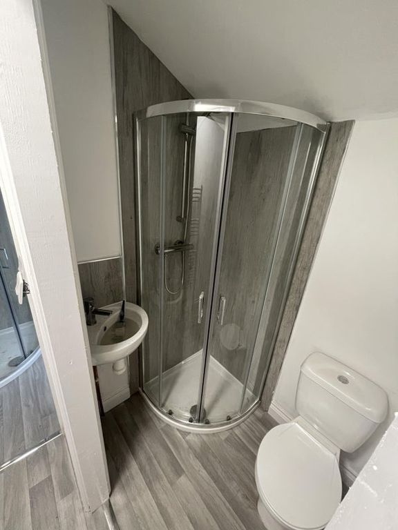Property photo 3 of 4 A Modern Bathroom Featuring A Curved Glass Shower ...