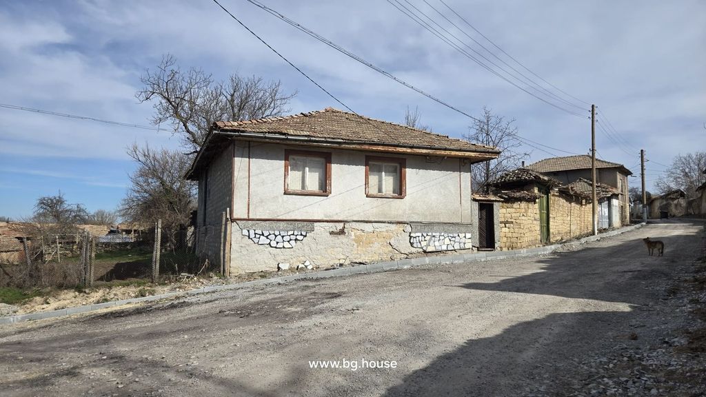 Property photo 3 of 40 Front View Of A Bulgarian Village House With A Tiled Roof And Two Windows Overlooking A Quiet Dirt Road.