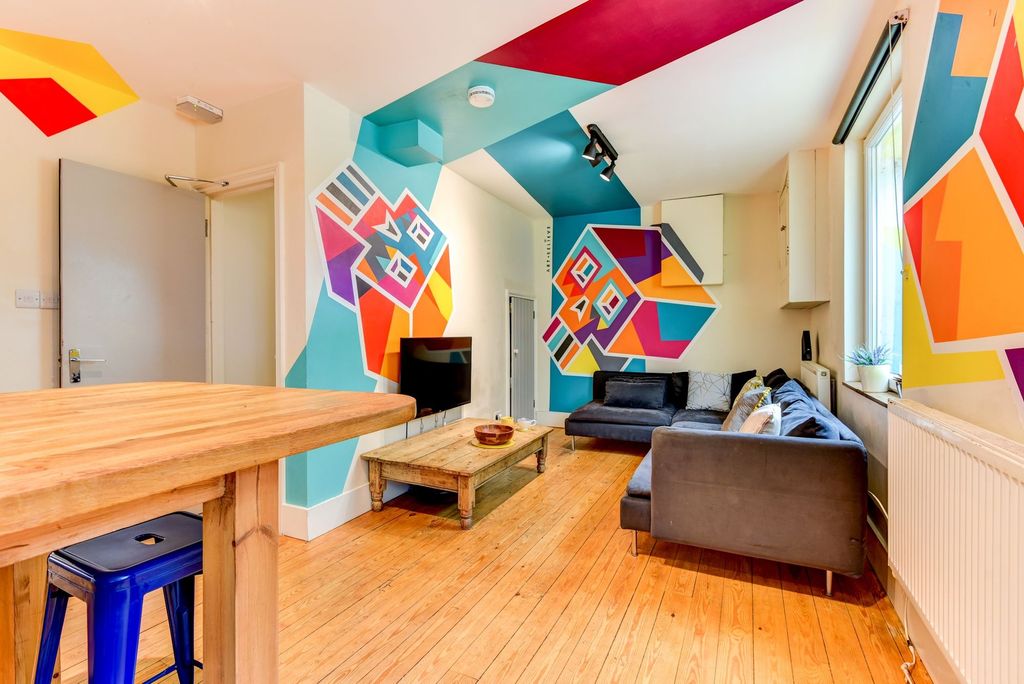 Property photo 1 of 5 A Vibrant Living Room With Colorful Geometric Wall...