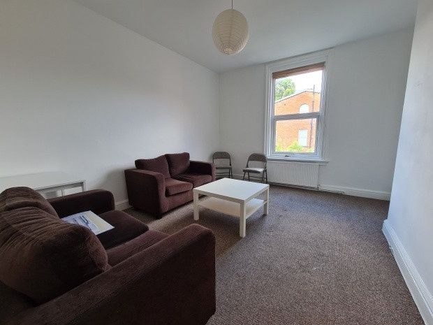 Property photo 1 of 9 A Spacious And Tidy Living Room Featuring Comforta...