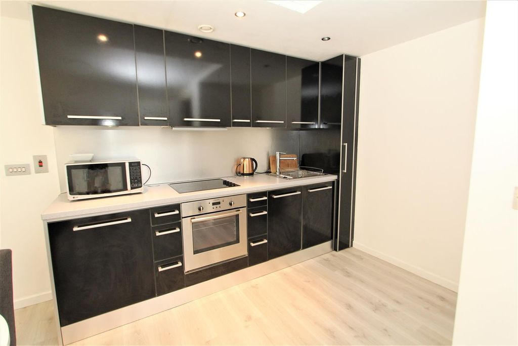 Property photo 3 of 7 Sleek Modern Kitchen With High-Gloss Cabinetry...