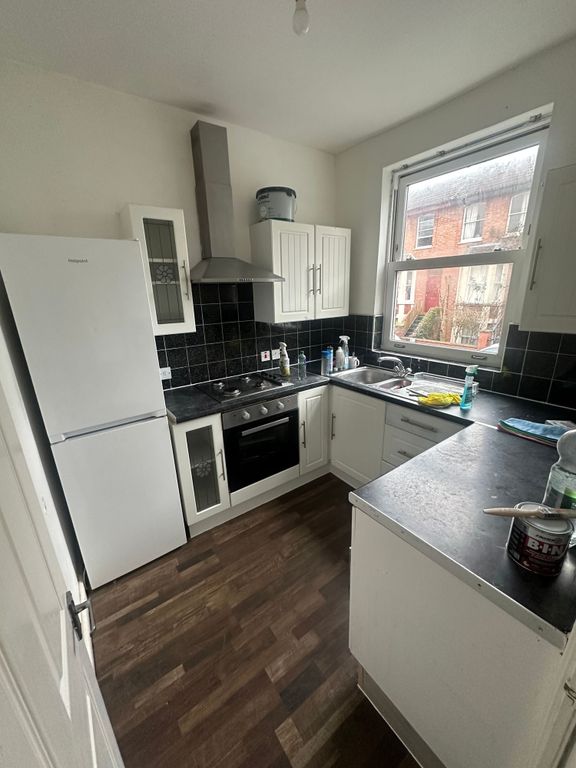 Property photo 2 of 8 Bright Galley-Style Kitchen With White Cabinetry, ...
