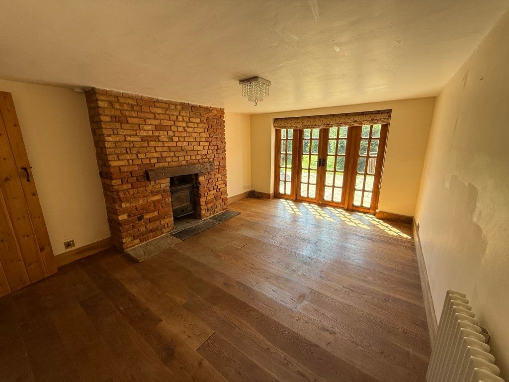 Property photo 2 of 15 Living Room With Fireplace And French Doors To Garden