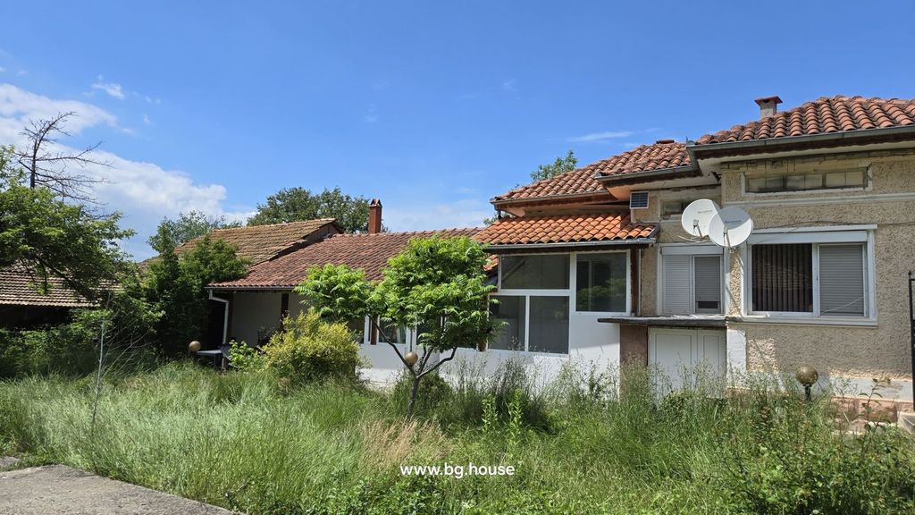 Property photo 2 of 55 Side Perspective Of The Bulgarian House Showing Tiled Roof, Enclosed Garden With Tall Grass And Small Trees.