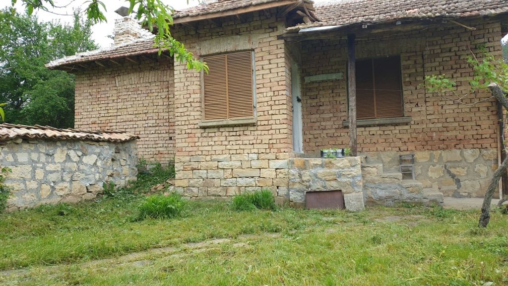 Property photo 3 of 50 Front Facade Of The Brick House Featuring A Stone Foundation And A Small Covered Porch Area