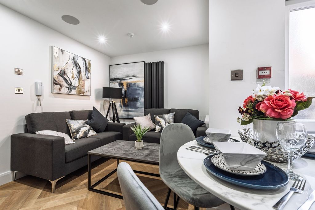 Property photo 1 of 4 Modern And Inviting Living Room Featuring A Comfor...