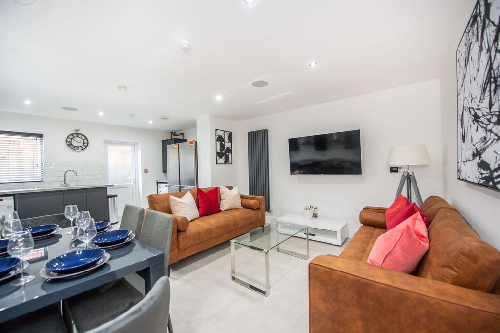 Property photo 1 of 6 A Modern, Well-Lit Living Room Featuring Two Large...