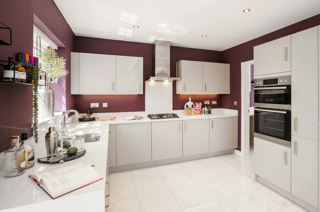 Property photo 3 of 10 A Modern, Well-Equipped Kitchen With White Cabinets, Stainless Steel Appliances