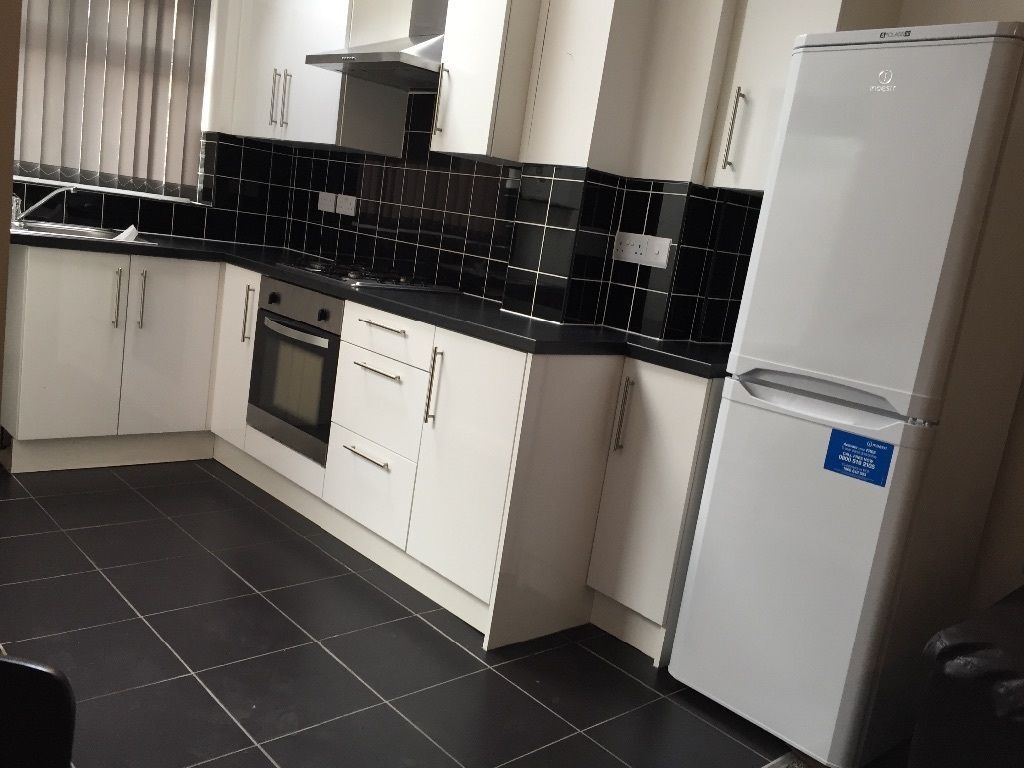 Property photo 2 of 12 Modern Kitchen With Sleek Black Tiling And Fridge...