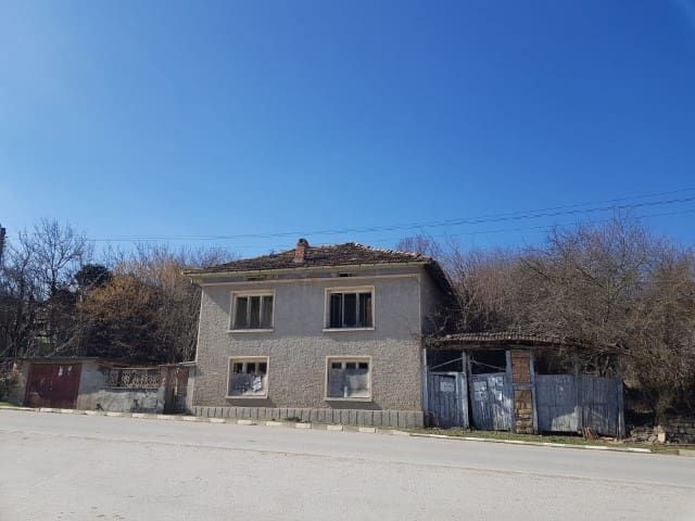 Property photo 2 of 39 Front Facade Of A Two-Storey House With Several Windows And A Gated Entrance Along A Paved Street
