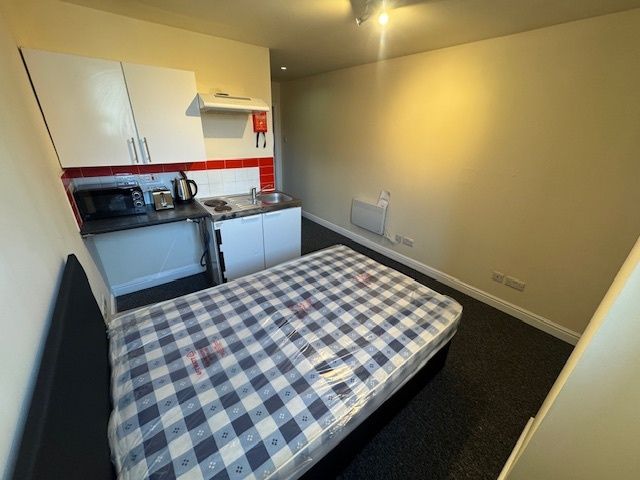 Property photo 1 of 4 A Compact Studio Apartment Featuring A Bed With A ...