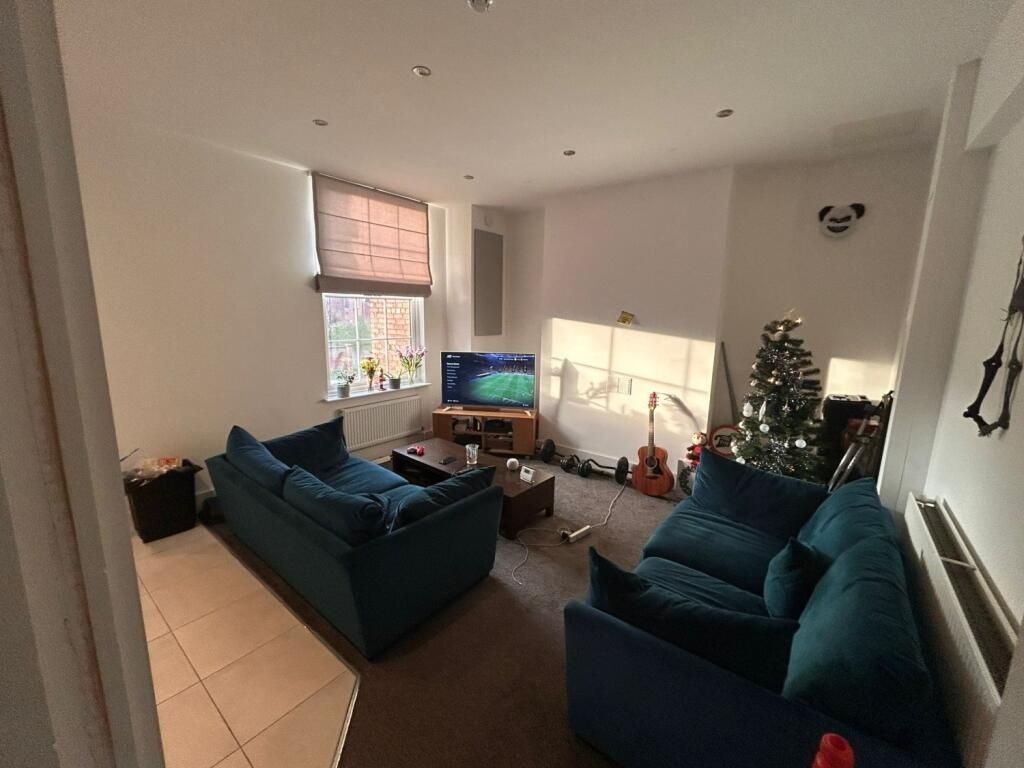 Property photo 3 of 13 A Cozy Living Room Featuring Comfortable Blue Sofa...