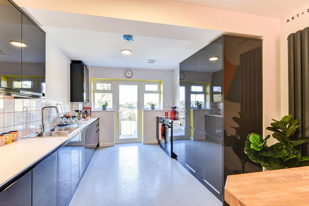Property photo 2 of 6 A Modern And Inviting Kitchen Featuring Sleek Cabi...