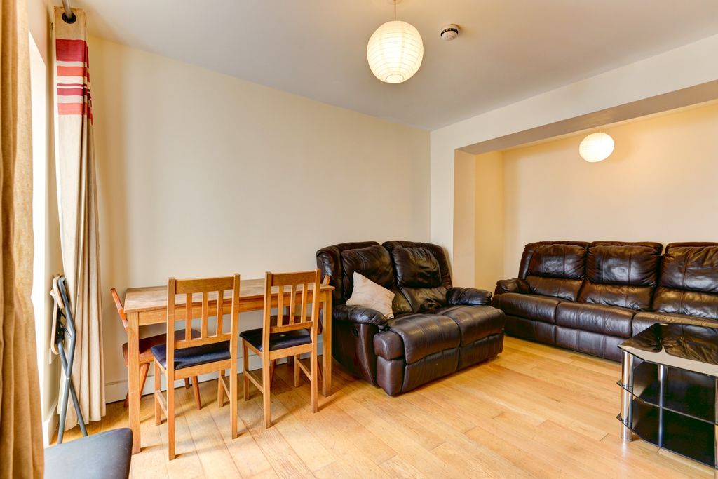 Property photo 2 of 29 A Spacious, Well-Lit Living Room Featuring Comfort...
