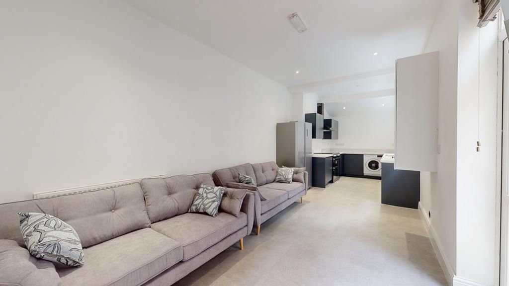 Property photo 3 of 12 A Spacious And Modern Living Room With Ample Seati...