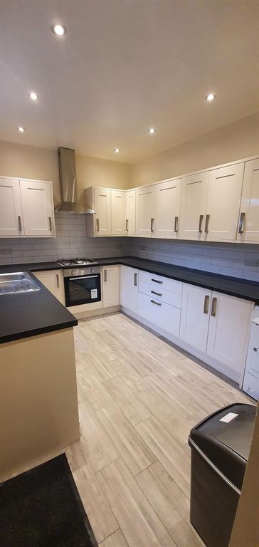 Property photo 1 of 4 Bright Modern Galley Kitchen With Ample White Cabi...