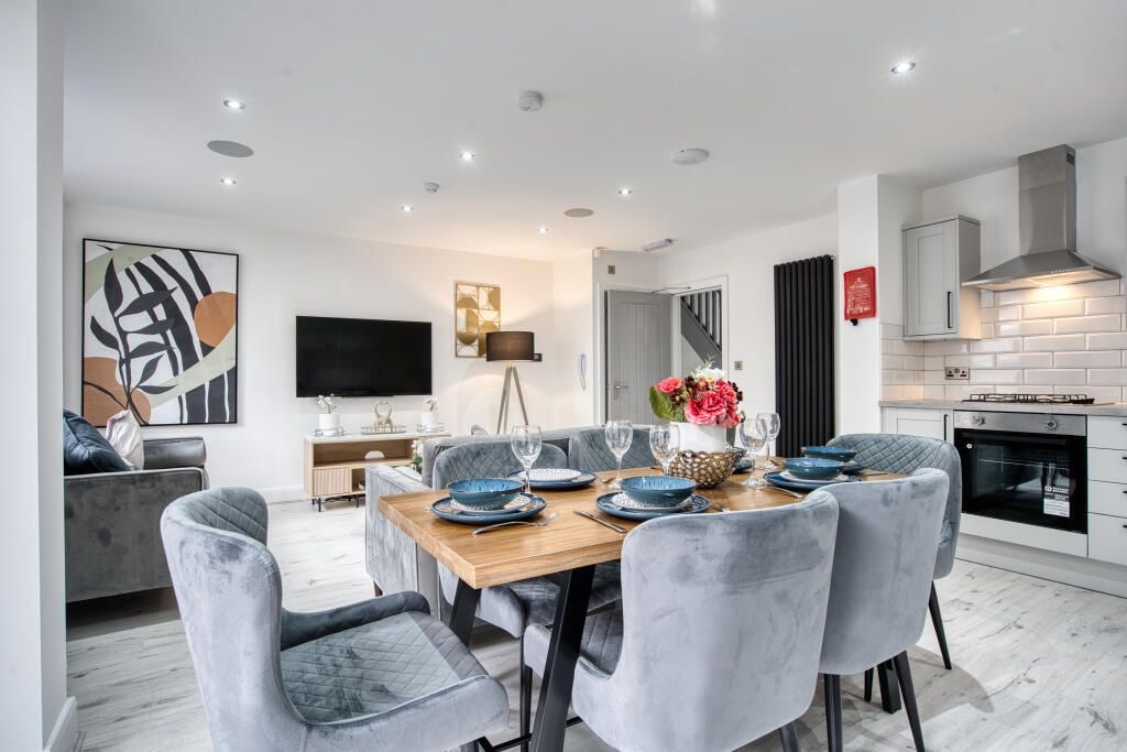 Property photo 2 of 15 A Modern, Well-Lit Living Room Featuring Contempor...